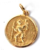 An 18ct St.Christopher pendant, the round pendant with St.Christopher on one side and a motor car on