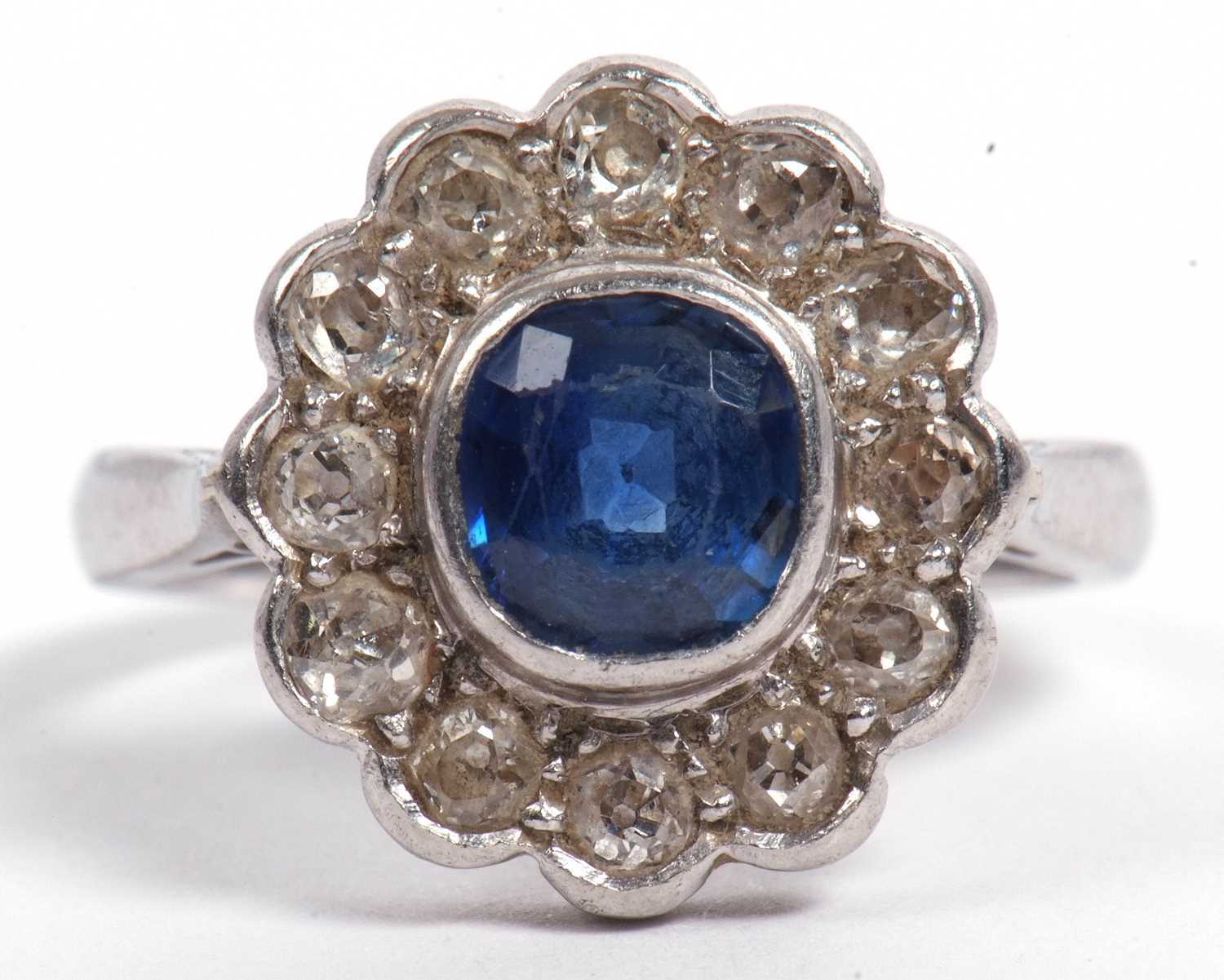 A sapphire and diamond cluster ring, the cushion shaped faceted sapphire is 7x7x4mm approx, bezel - Image 4 of 11