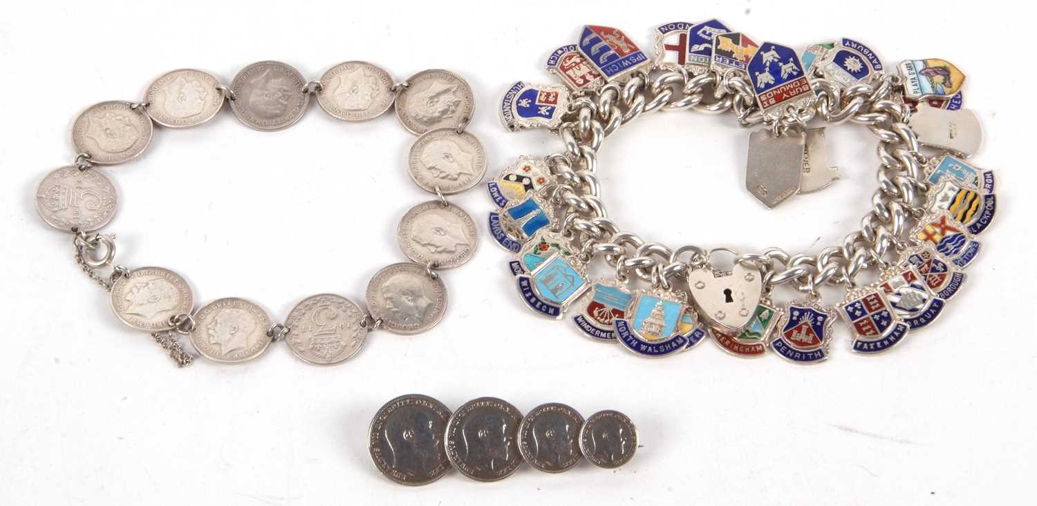 A threepence coin bracelet and a coin brooch, 23g, together with a silver and enamel charm bracelet,