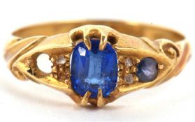 An 18ct sapphire ring, set with diamond highlights, with scrolled shoulders and plain band