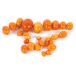 A quantity of butterscotch amber beads, the largest approx. 3.5cm x 2.5cm, 85g gross