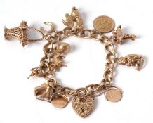 A 9ct curblink charm bracelet, with heart shape padlock clasp with engraved decoration to one