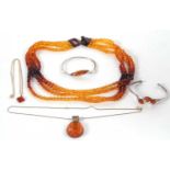 A quantity of amber jewellery to include a four strand faceted amber bead necklace, 40g, two