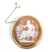 An unmarked oval shell cameo, depicting a classical seated figure holding a staff, in unmarked