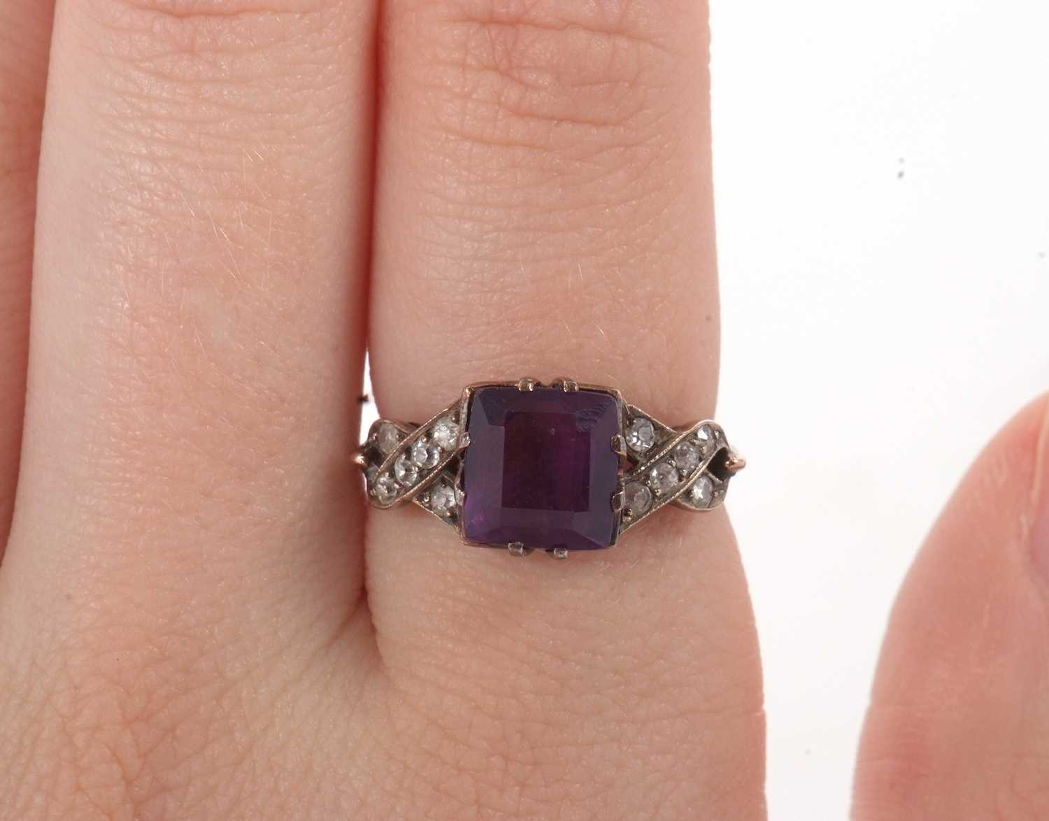 An amethyst and diamond ring, the modified square cut amethyst, claw mounted with crossover - Image 8 of 8