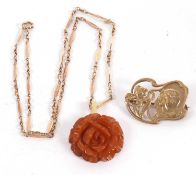 A carved amber pendant and chain, the amber pendant carved in the shape of a rose, 2.9cm diameter,