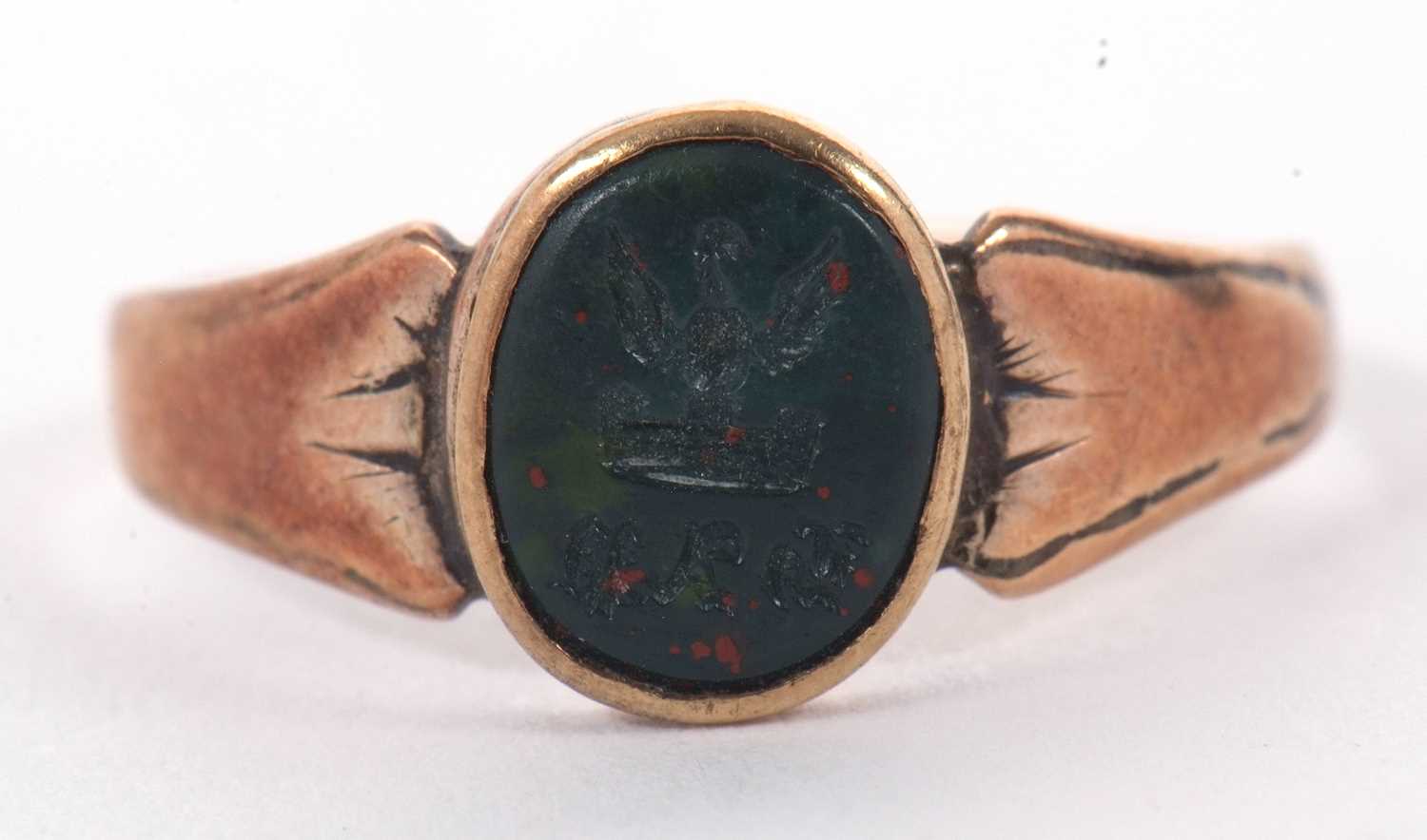 A bloodstone signet ring, the oval bloodstone with incised insignia, collet mounted with tapering