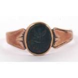 A bloodstone signet ring, the oval bloodstone with incised insignia, collet mounted with tapering