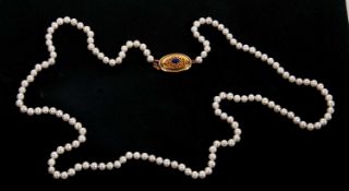 A cultured pearl necklace, the round cultured pearls, each approx. 5.7mm diameter, with oval clasp
