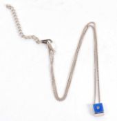 A silver, diamond and blue enamel pendant, the square pendant set with blue enamel and a small round