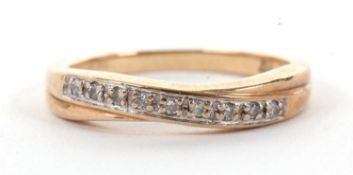 A 9ct diamond ring, with crossover style band, band stamped 0.10, stamped 375 with Sheffiled assay