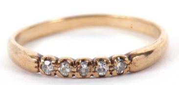 A 9ct diamond ring, the plain narrow band set with five smalll round diamonds, plain band stamped