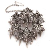 A white metal filigree brooch, the round frame, 4cm diameter, set with a central rosette and