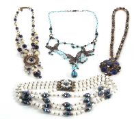 A necklace by Yve Speight, the blue, cream and gilt glass beads with gilt metal spacers and sunburst