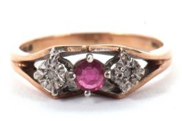 A 9ct ruby and diamond ring, the central claw mounted round ruby set to either side with a small