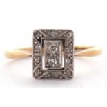 An Edwardian 18ct diamond ring, the rectangular plaque set with single and rose cut diamonds, all