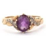 A 9ct amethyst and diamond ring, the oval amethyst with crossover style shoulders set with small