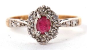 An 18ct and platinum ruby and diamond ring, the oval ruby with illusion set round single cut