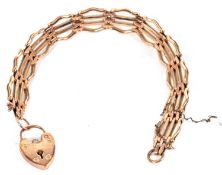 A 9ct gate bracelet, the gate link style bracelet set with hert shape padlock clasp stamped 9ct,
