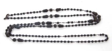 A bog oak necklace, comprised of round, carved and acorn shaped beads with metal spacers, overall