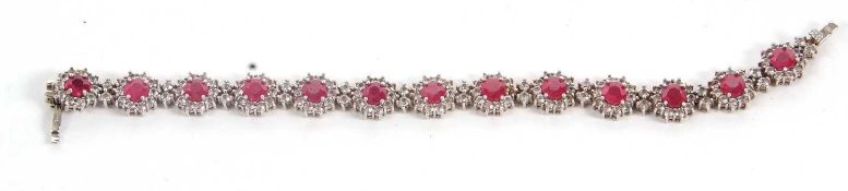 A ruby and white topaz bracelet, comprised of 15 clusters of round rubies surrounded by small
