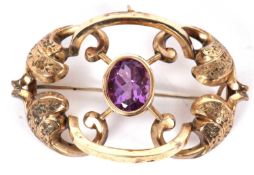 A Victorian amethyst brooch, the oval collet mounted amethyst, set within an X-frame with
