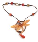 A dragonfly pendant in the manner of Elizabeth Bonte, the carved and painted horn pendant with glass