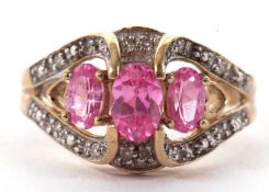 A 9ct pink gemstone and diamond ring, the three oval pink gemstones, claw mounted with shaped