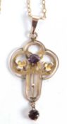 An Edwardian amethyst and garnet pendant, hanging loop stamped 9ct, with tapered bale, 4.5cm long,