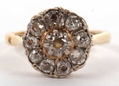 An 18ct diamond cluster ring, the central round raised diamond surrounded by mixed cut diamonds, all