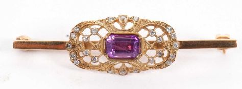 A 9ct amethyst and diamond bar brooch, set to centre with an emerald cut amethyst within a pierced
