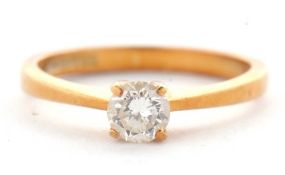 An 18ct diamond solitaire ring, the round brilliant cut diamond estimated approx. 0.37cts, in a four