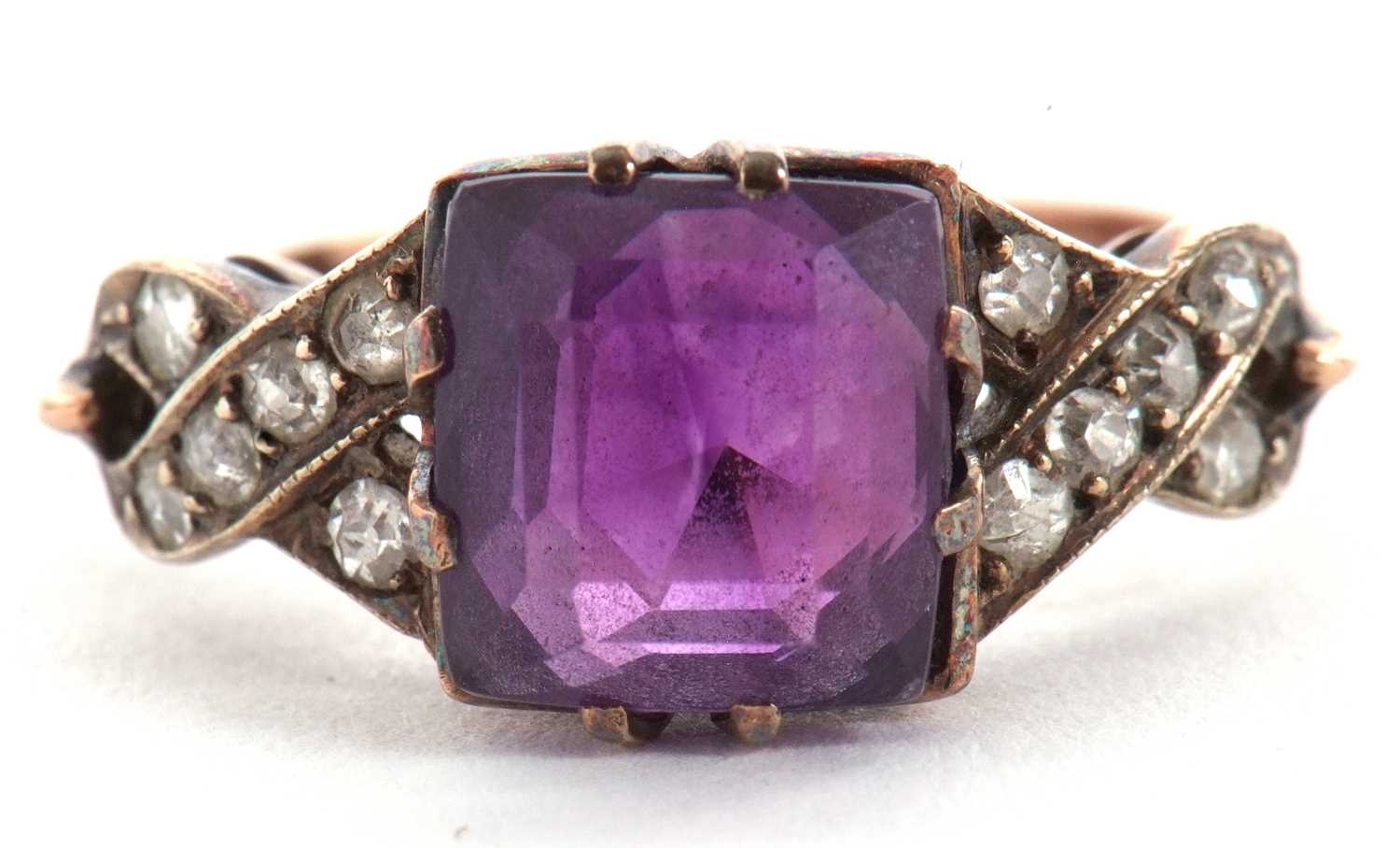 An amethyst and diamond ring, the modified square cut amethyst, claw mounted with crossover