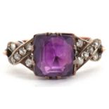 An amethyst and diamond ring, the modified square cut amethyst, claw mounted with crossover