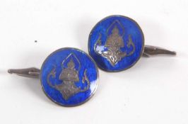 A pair of Eastern silver and blue enamel cufflinks, the round discs with blue enamel background