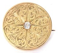 An 18ct diamond brooch/pendant, the round disc set to centre with an old mine cut diamond, estimated