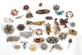 A quantity of brooches to include an enamel and paste set owl, an enamel and paste set bird of