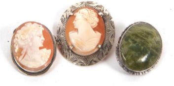 Two cameos and a brooch: an oval shell cameo with textured silver surround, stamped 'silver' to