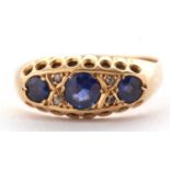 An early 20th century 18ct sapphire and diamond ring, the three round graduated sapphires