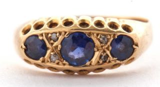 An early 20th century 18ct sapphire and diamond ring, the three round graduated sapphires