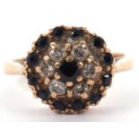 A 9ct sapphire and diamond cluster ring, set with a central small round sapphires surrounded by a
