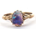A 9k opal ring, the oval opal cabochon, claw mounted to a plain band indistinctly stamped 9k, size