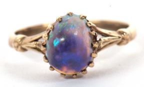 A 9k opal ring, the oval opal cabochon, claw mounted to a plain band indistinctly stamped 9k, size