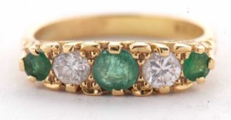 An 18ct emerald and diamond ring, set with alternating round emeralds and round brilliant cut
