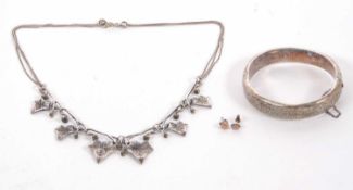 A silver ivy leaf necklace, the naturalistic modelled ivy leaves with curled tendrils and bead