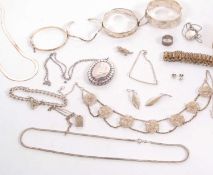A quantity of silver and white metal jewellery to include three hinged silver bangles, an open ended