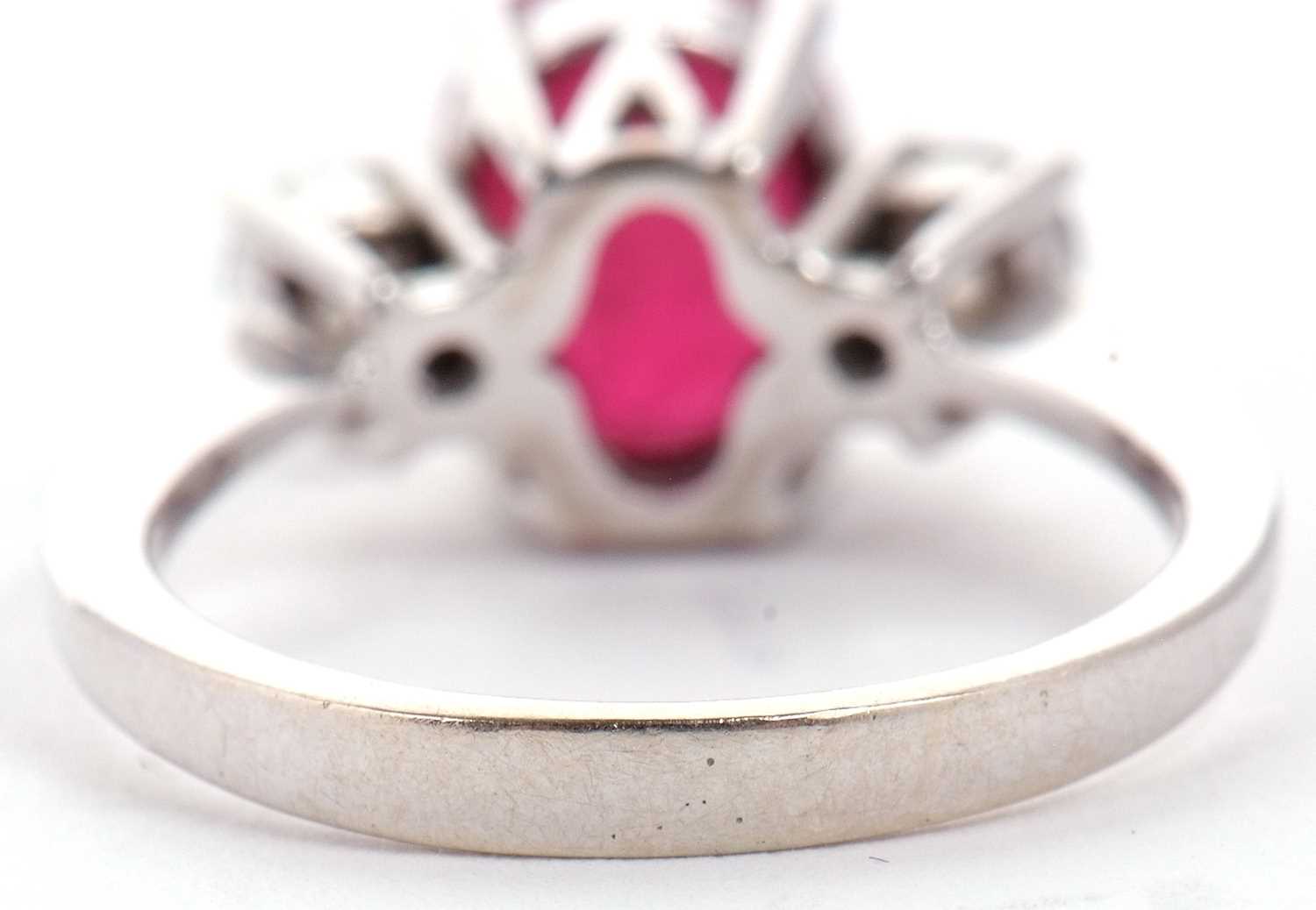 A 14ct white gold ruby and diamond ring, the oval mixed cut ruby, approx. 9.1 x 7.1 x 5.1mm, set - Image 6 of 10