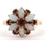 A 9ct opal and garnet flowerhead ring, the central round garnet surrounded by oval opal cabochons