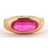 A continental synthetic ruby ring, the oval mixed cut synthetic ruby collet mounted with engraved