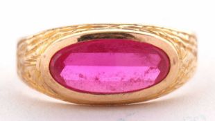 A continental synthetic ruby ring, the oval mixed cut synthetic ruby collet mounted with engraved